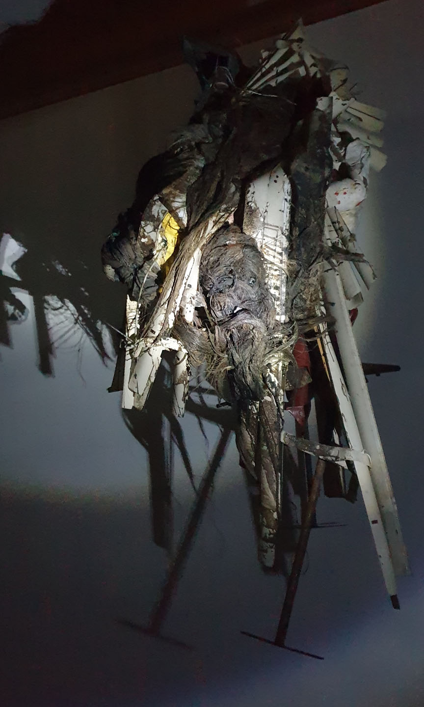 Man sieht eine Kunstinstallation im dunklen, welche nur mit einer Taschenlampe beleuchtet wird.