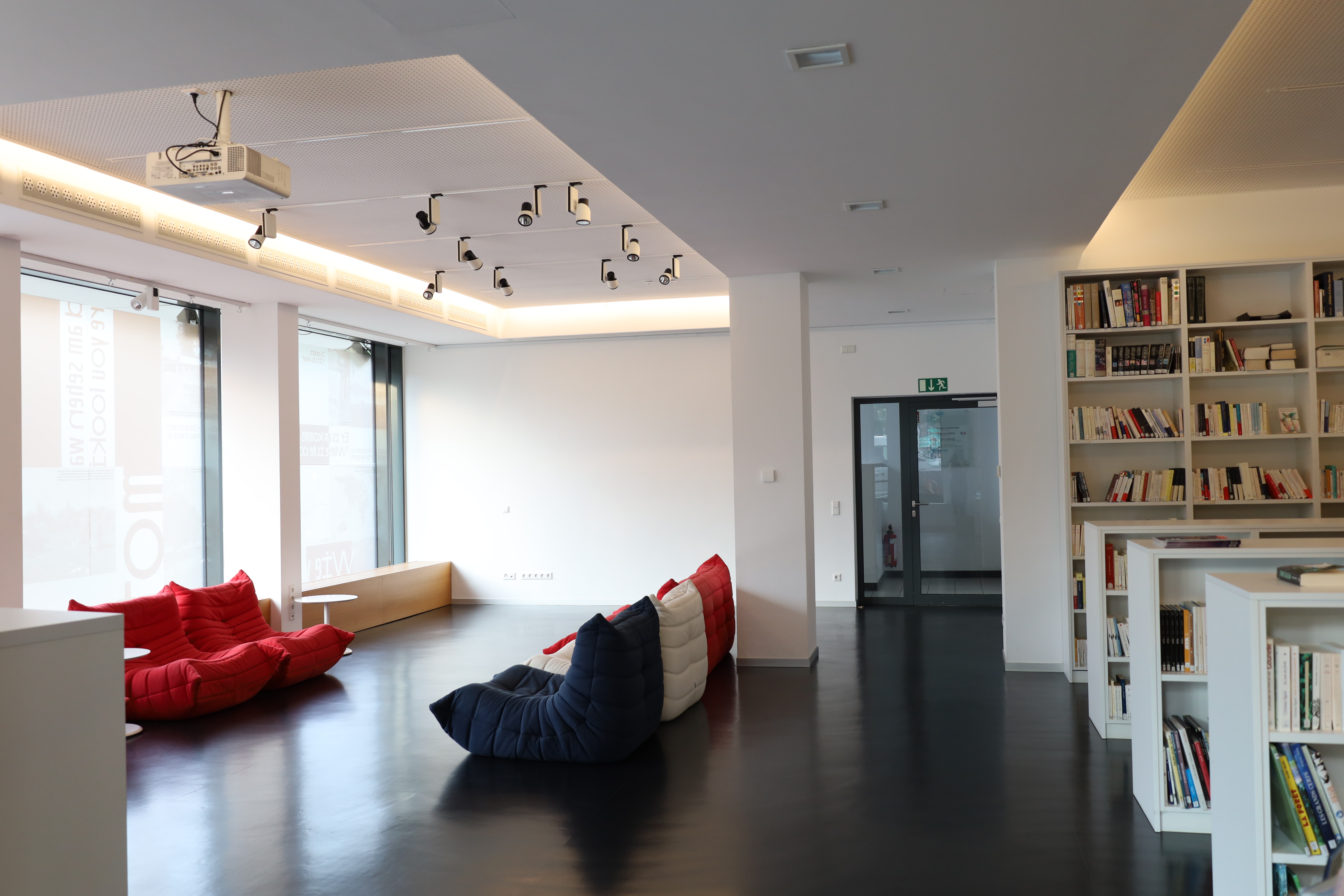 Einen Raum mit einem rot, weiß, blauen Sofa.