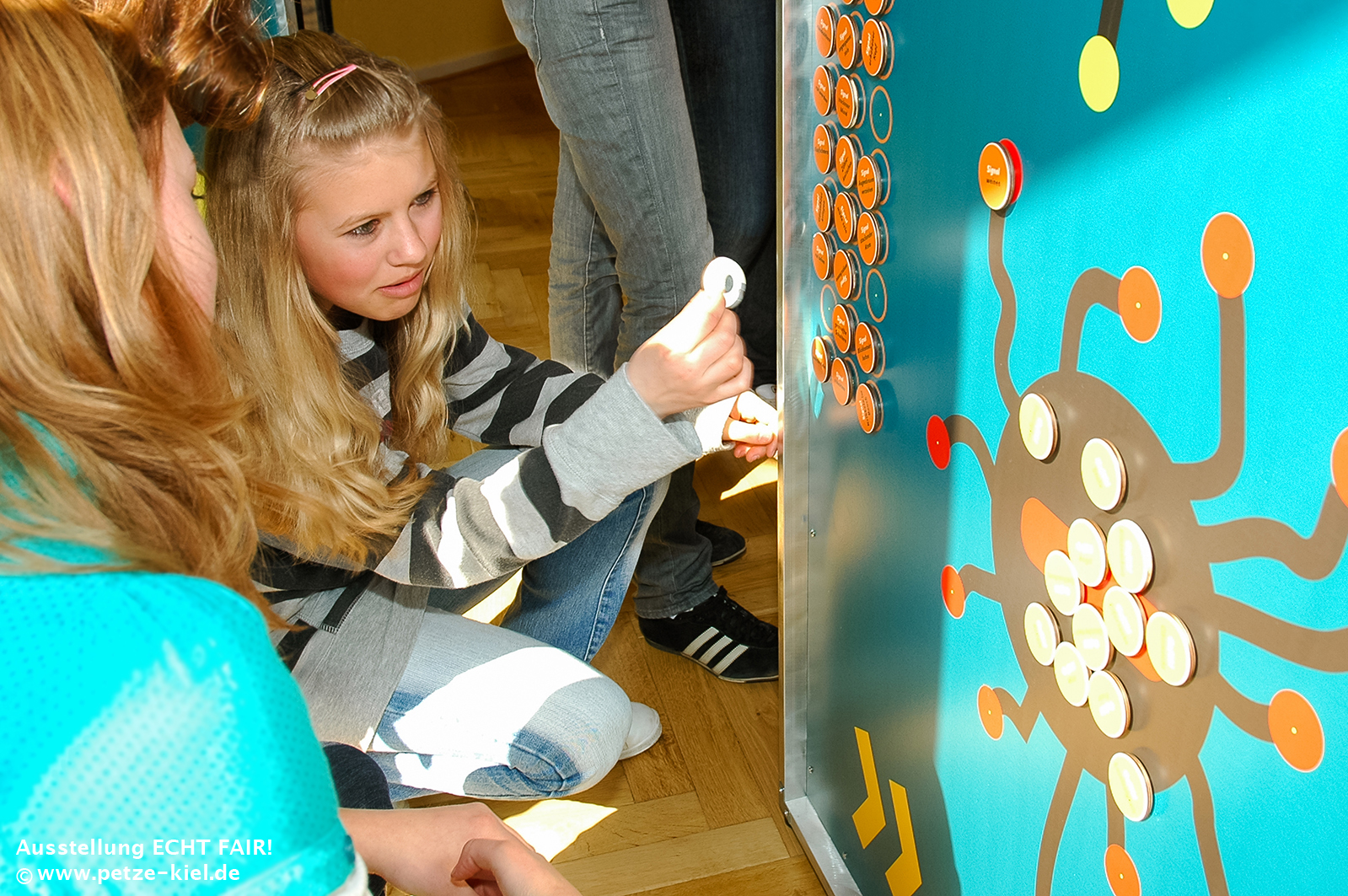 Ausstellungsbesucherinnen an einer Mitmach-Tafel.